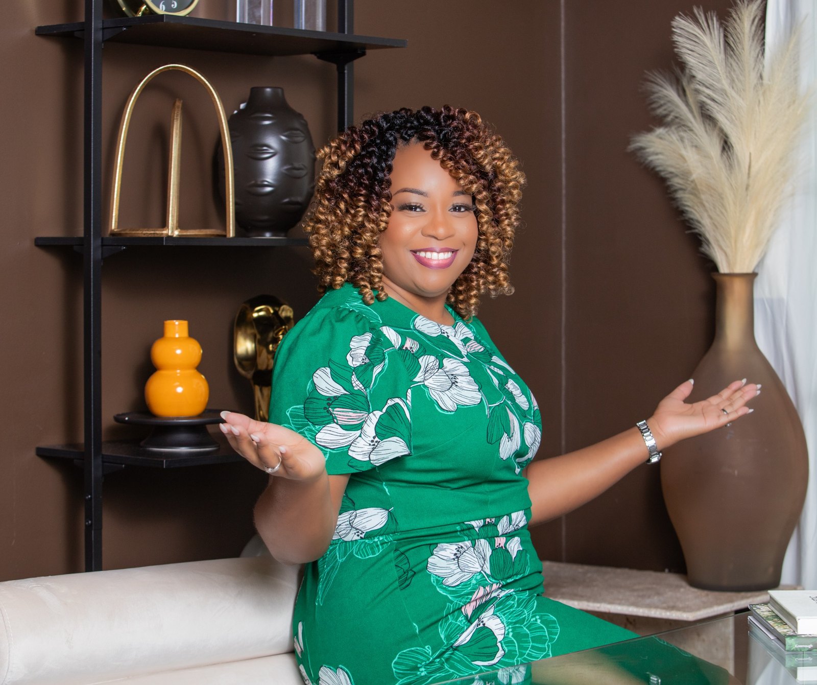 Chris Deshields, founder of Executive Clean Team, wearing an emerald green dress in a refined interior